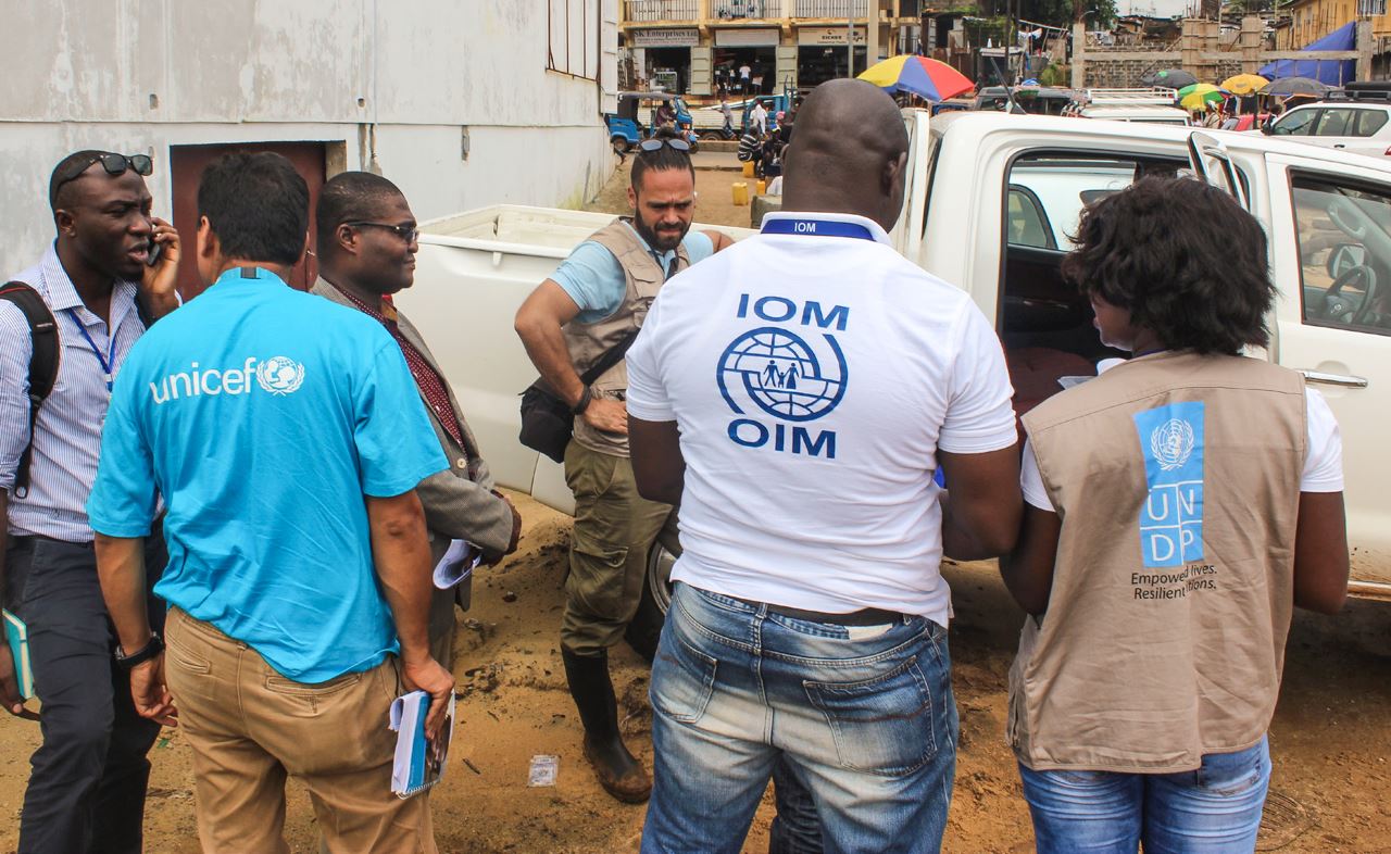 UN workers in front of pickup