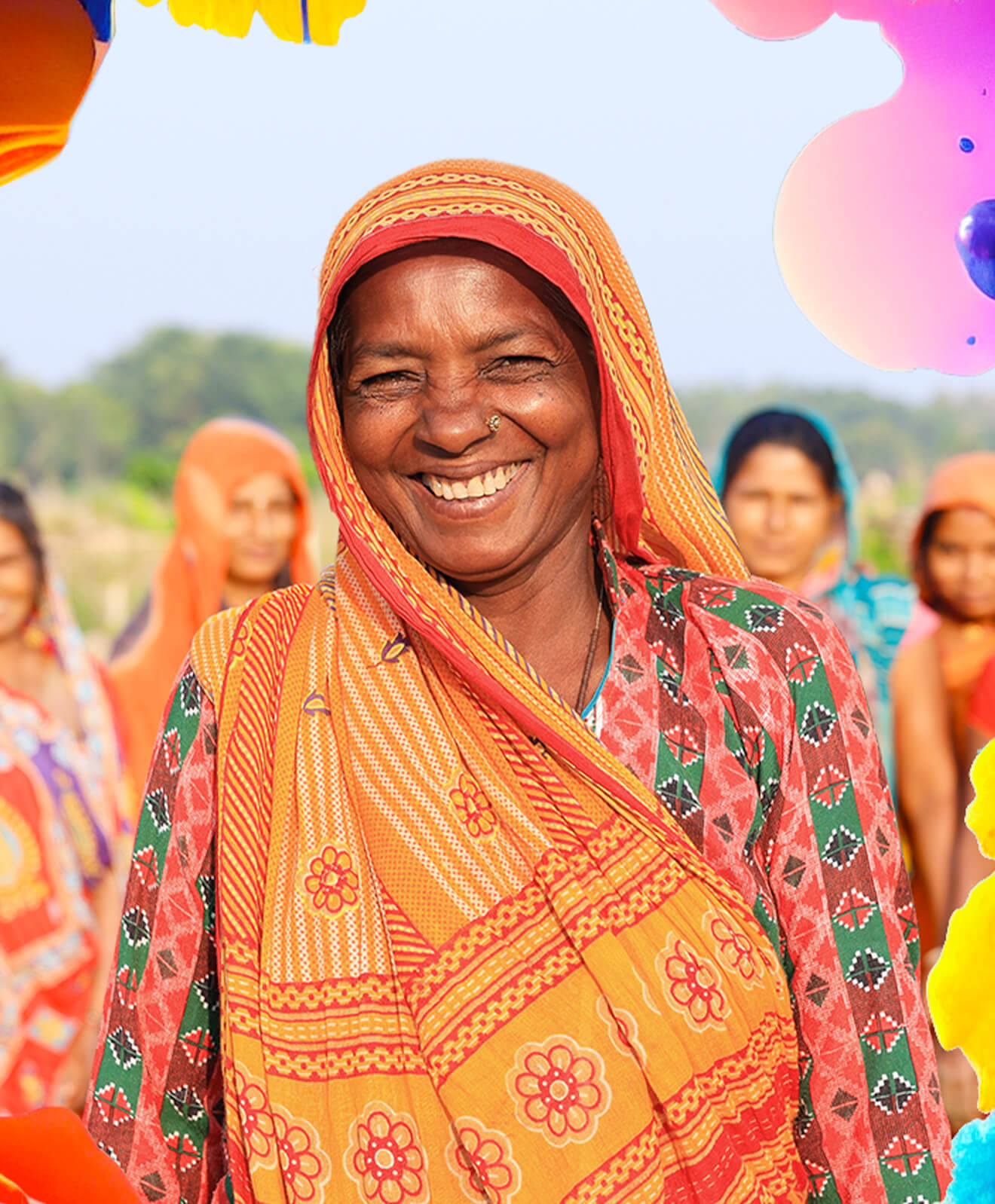 Photo of a smiling Nepalese woman with other women smiling in the background