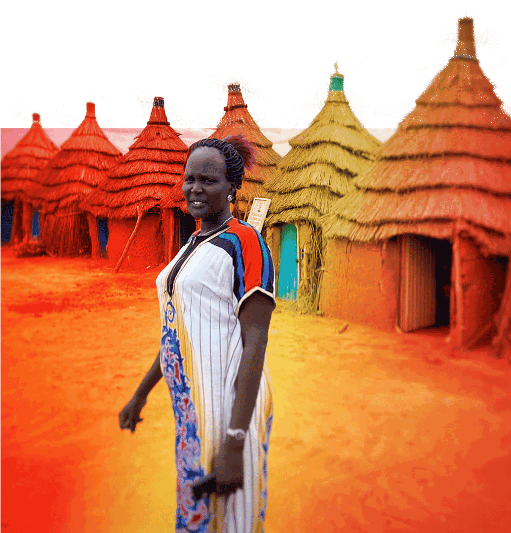 Sudanese woman in front of houses